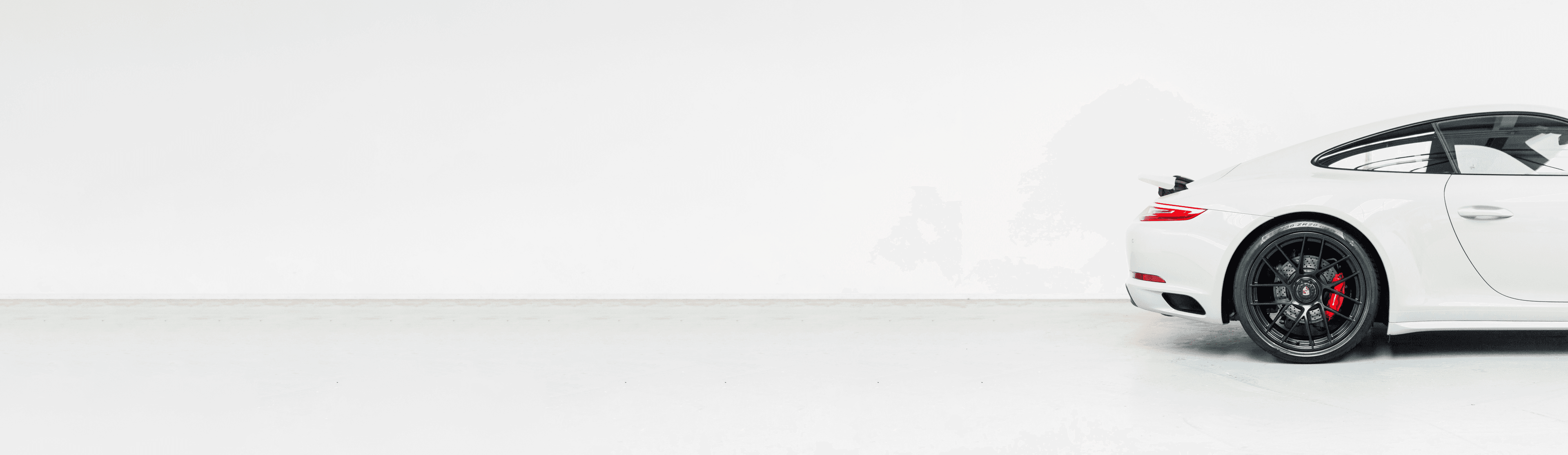 A white Porsche in a clean garage